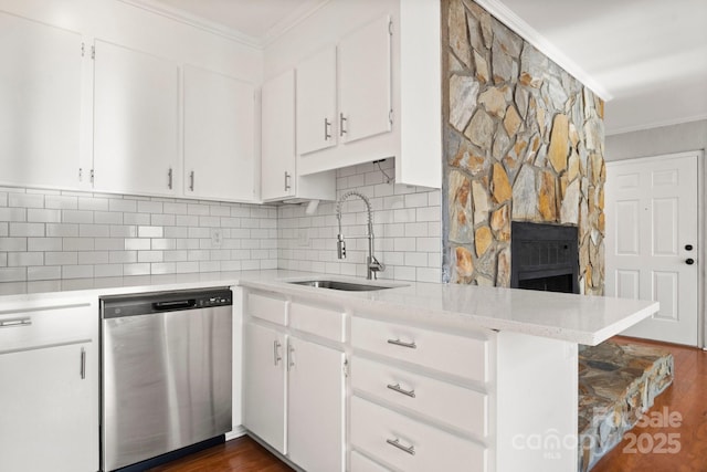 kitchen featuring a sink, ornamental molding, white cabinets, and stainless steel dishwasher