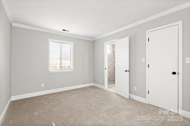 unfurnished bedroom with baseboards, visible vents, ornamental molding, ensuite bathroom, and carpet flooring