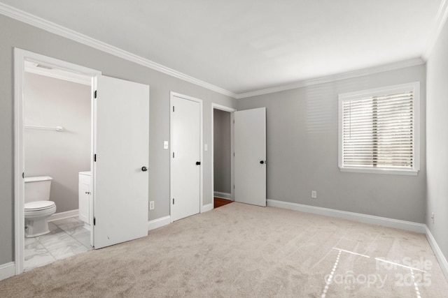 unfurnished bedroom featuring carpet, ensuite bath, baseboards, and crown molding