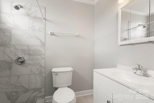 bathroom with ornamental molding, marble finish floor, and a tile shower