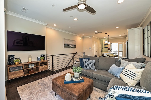 living room with crown molding, wood finished floors, visible vents, and recessed lighting