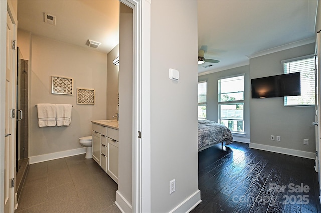 bathroom with a healthy amount of sunlight, baseboards, visible vents, and a ceiling fan