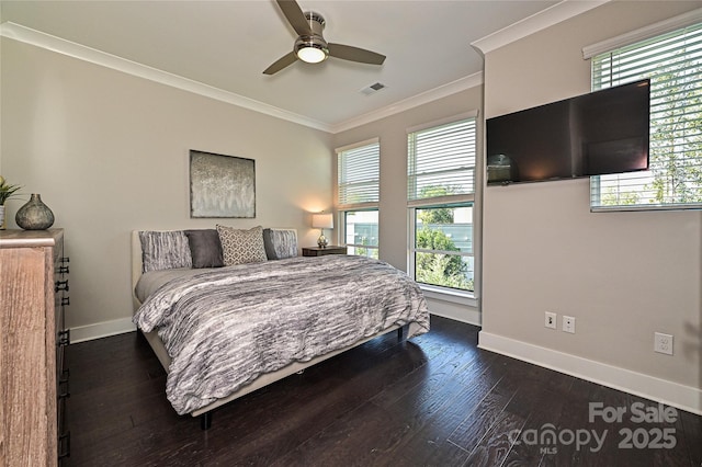 bedroom with baseboards, visible vents, crown molding, and wood finished floors