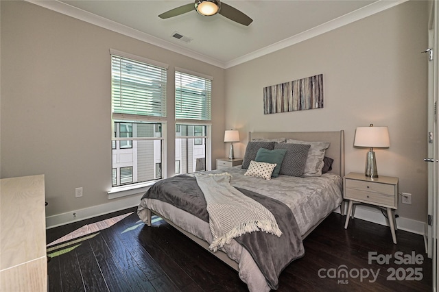 bedroom featuring baseboards, dark wood-style flooring, visible vents, and crown molding