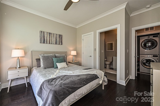 bedroom featuring ornamental molding, stacked washer and clothes dryer, and dark wood-type flooring