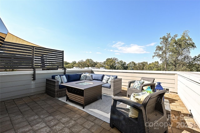 view of patio with an outdoor living space with a fire pit