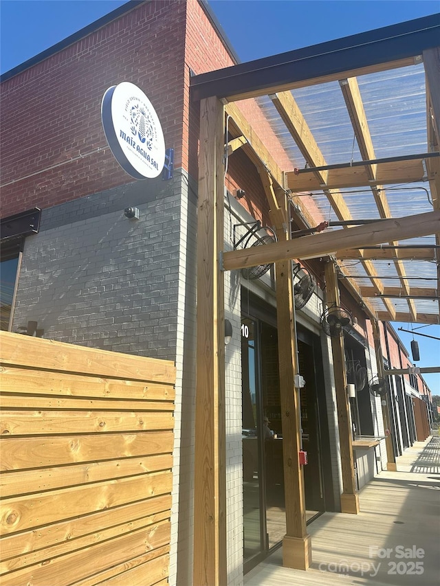 entrance to property featuring brick siding