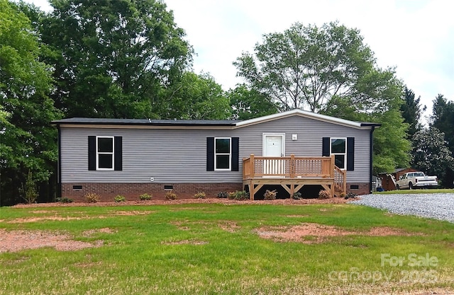 view of front of house with a front lawn, crawl space, and a wooden deck