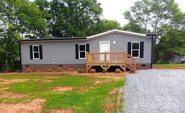 view of front facade with a wooden deck, a front lawn, and crawl space