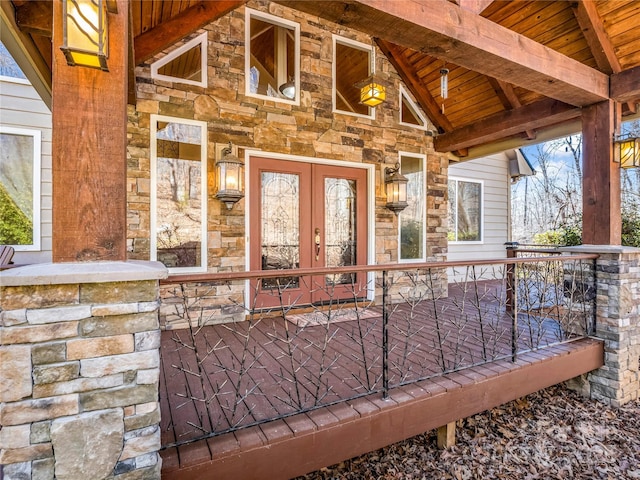 property entrance with french doors and stone siding