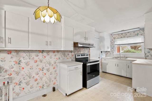 kitchen with wallpapered walls, under cabinet range hood, light floors, light countertops, and electric stove