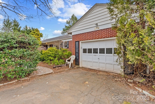 view of front facade with brick siding and driveway