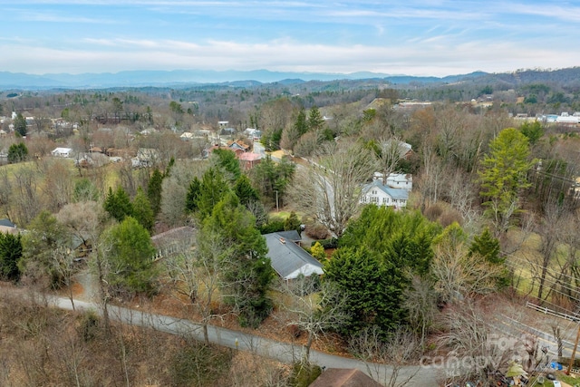 aerial view with a mountain view and a forest view