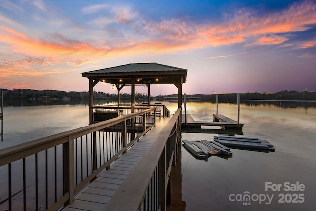 view of dock with a water view and a gazebo