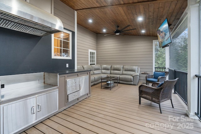 wooden terrace with an outdoor kitchen, an outdoor living space, and a ceiling fan