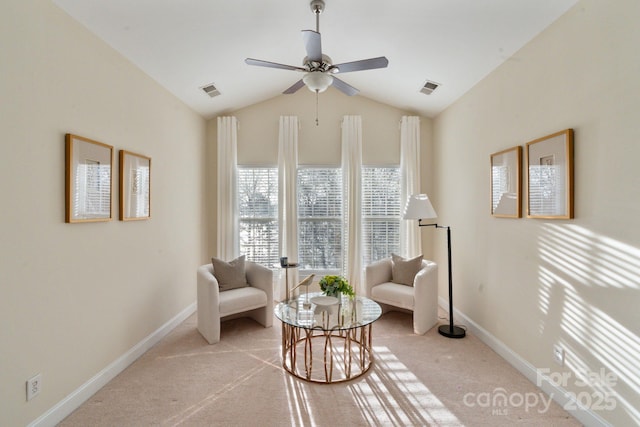 sitting room featuring lofted ceiling, baseboards, visible vents, and light colored carpet