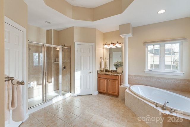 full bath featuring tile patterned flooring, vanity, a shower stall, a bath, and ornate columns