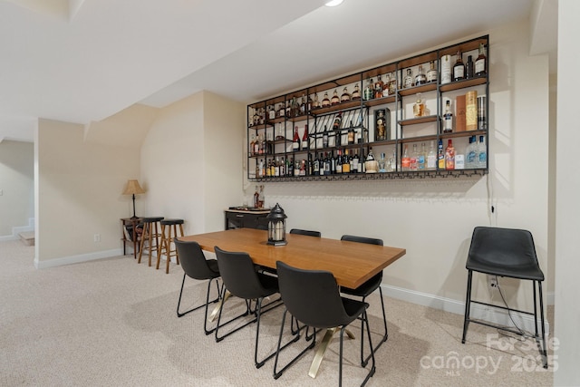 dining room with carpet flooring and baseboards