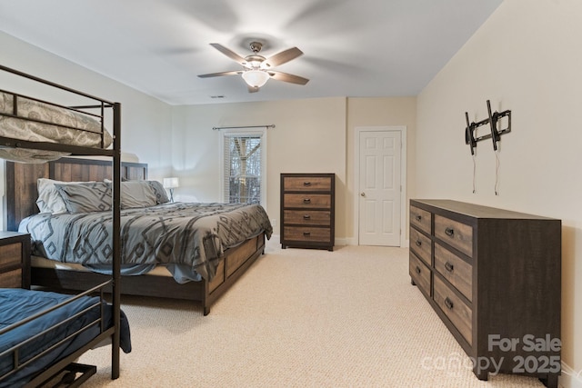 bedroom with a ceiling fan, light colored carpet, visible vents, and baseboards