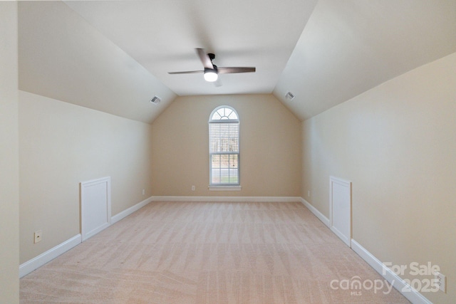 bonus room with a ceiling fan, lofted ceiling, carpet flooring, and baseboards