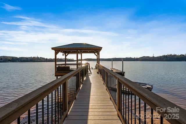 view of dock featuring a water view and a gazebo