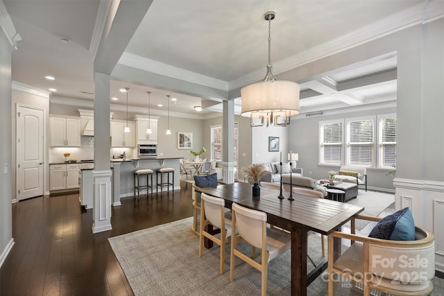 dining room featuring dark wood finished floors, beamed ceiling, recessed lighting, coffered ceiling, and ornate columns