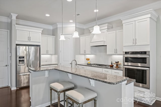 kitchen with dark wood finished floors, custom exhaust hood, white cabinets, and stainless steel appliances