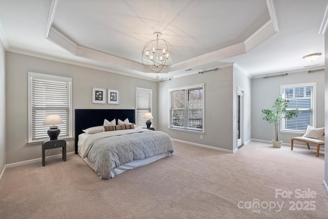 bedroom featuring a notable chandelier, a tray ceiling, carpet flooring, crown molding, and baseboards