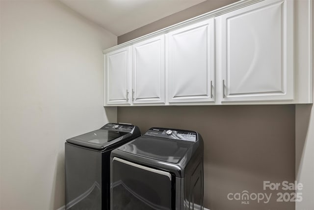 laundry area featuring washing machine and dryer and cabinet space