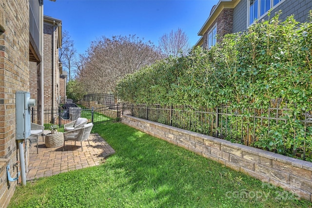 view of yard with a fenced backyard and a patio