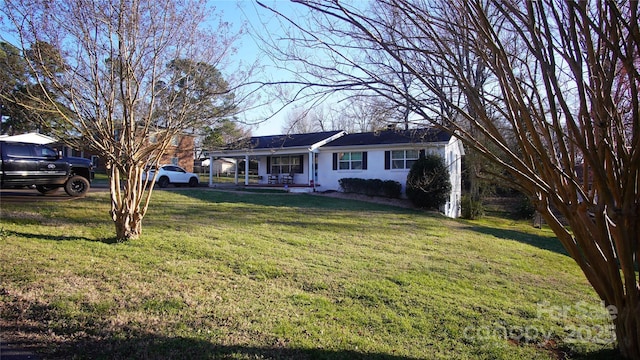 ranch-style home with a front lawn