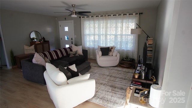 living room with ceiling fan and wood finished floors