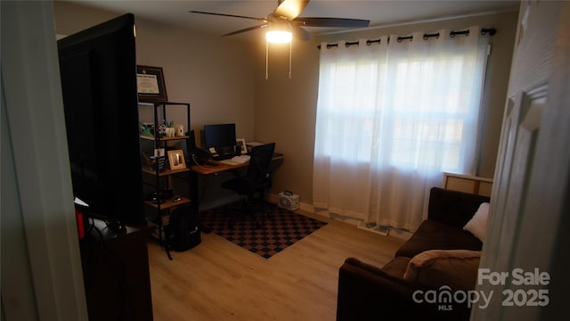 office space with ceiling fan and wood finished floors