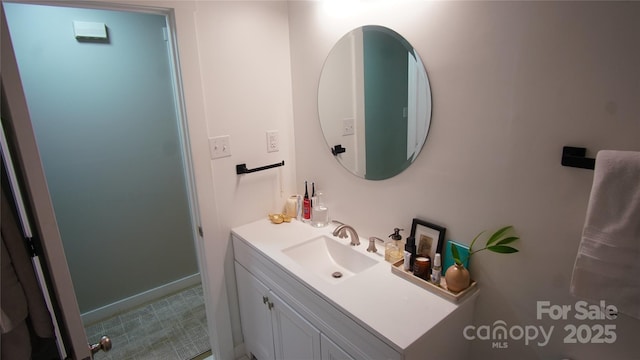 bathroom featuring baseboards and vanity