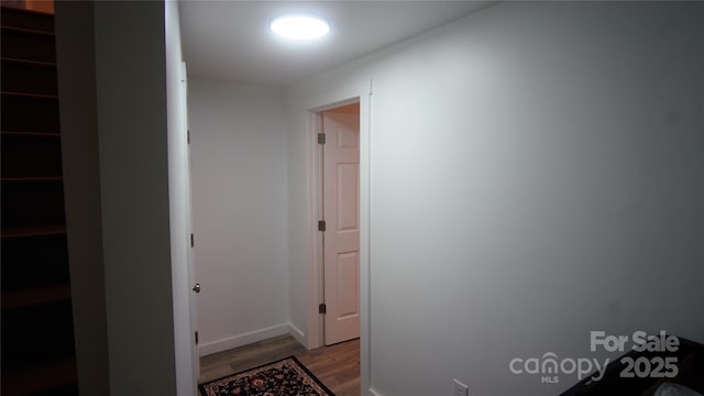 corridor featuring wood finished floors