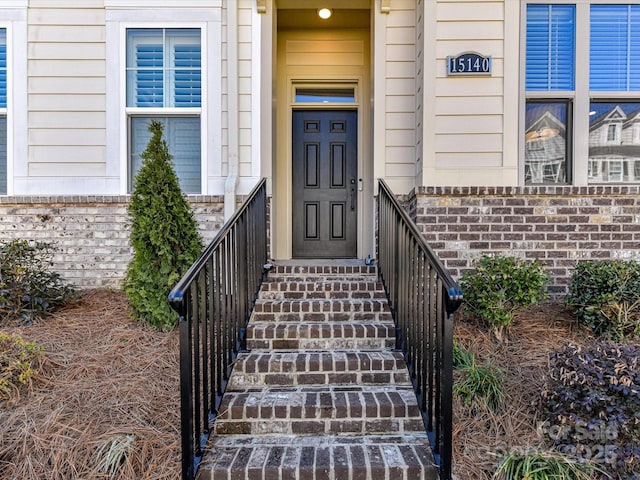 property entrance featuring brick siding