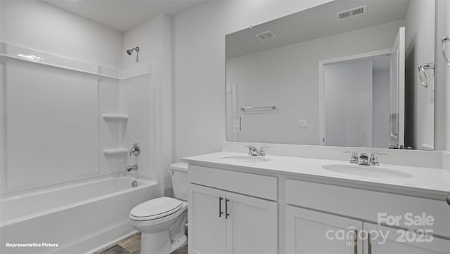 bathroom featuring toilet, visible vents, and a sink