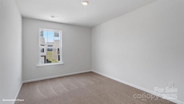 empty room featuring carpet, visible vents, and baseboards