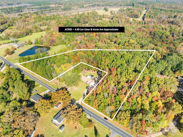 drone / aerial view featuring a water view and a view of trees