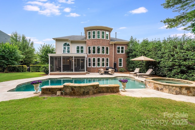 back of house with a patio, an in ground hot tub, a sunroom, a lawn, and an outdoor pool