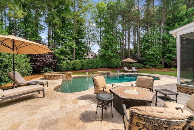 view of pool featuring a fenced in pool, a patio area, a fire pit, and an in ground hot tub