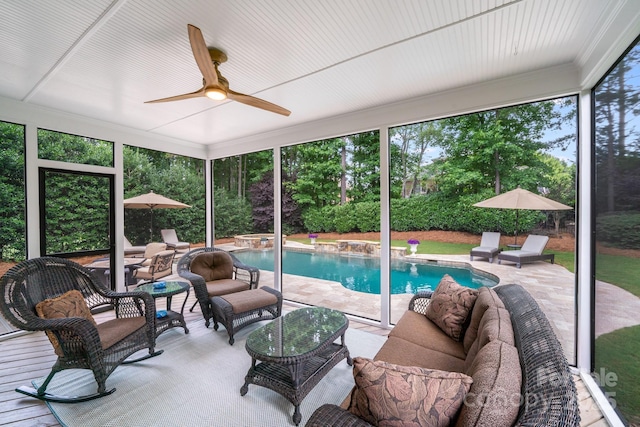 sunroom / solarium featuring a wealth of natural light and ceiling fan