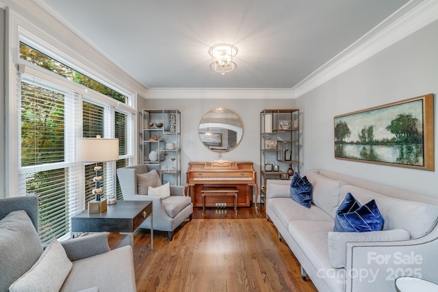 living area featuring ornamental molding and wood finished floors