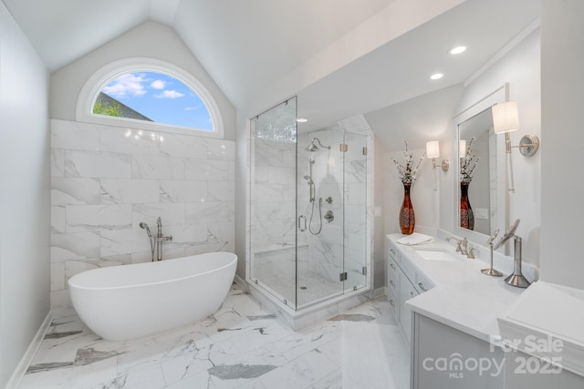 full bathroom with a stall shower, lofted ceiling, marble finish floor, vanity, and a freestanding tub