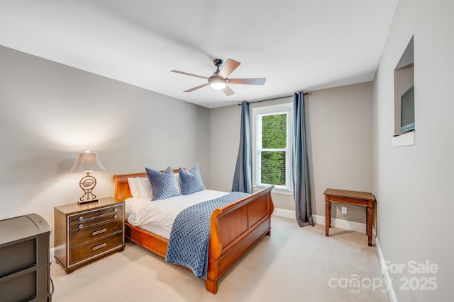 bedroom with light carpet, baseboards, and a ceiling fan