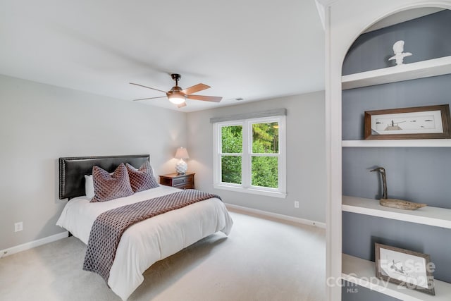 carpeted bedroom featuring ceiling fan and baseboards