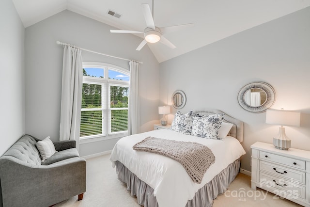 bedroom featuring light colored carpet, a ceiling fan, baseboards, vaulted ceiling, and visible vents