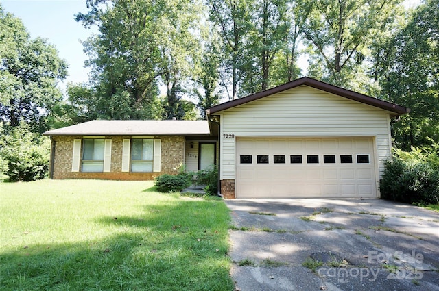 single story home featuring a garage, brick siding, driveway, and a front lawn