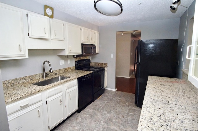 kitchen featuring black appliances, a textured ceiling, white cabinetry, and a sink