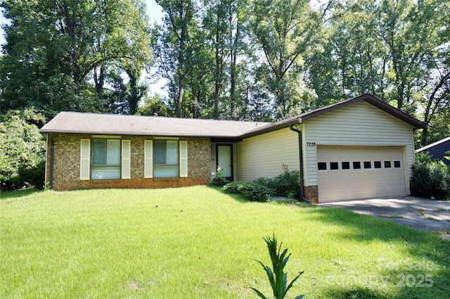 ranch-style home featuring a garage, driveway, brick siding, and a front yard